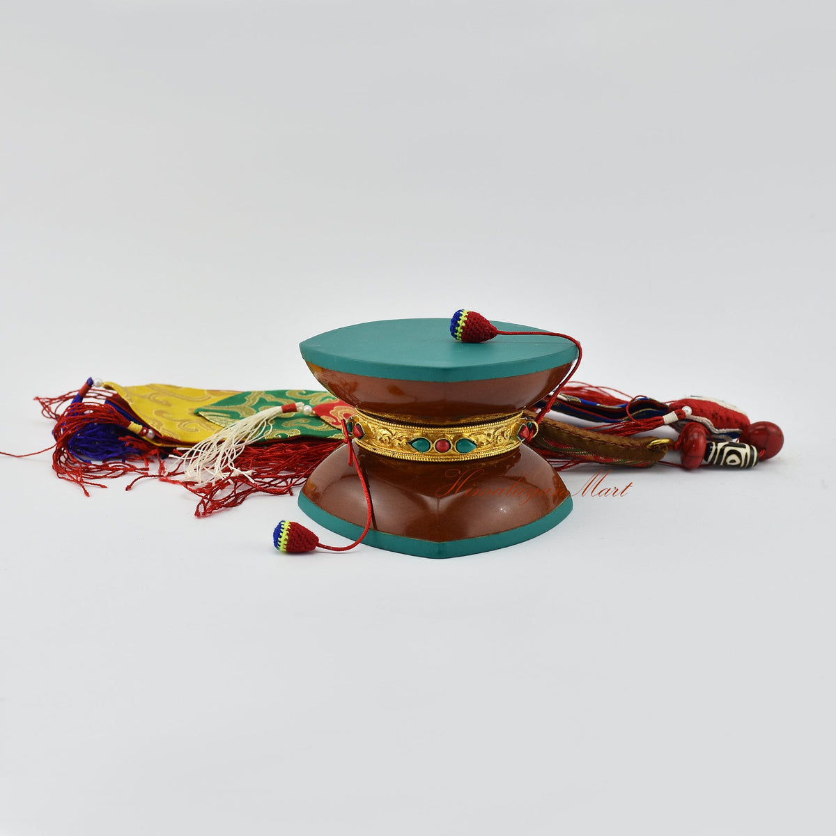 Handcrafted damaru ritual drum with silk tail used in Vajrayana Buddhism