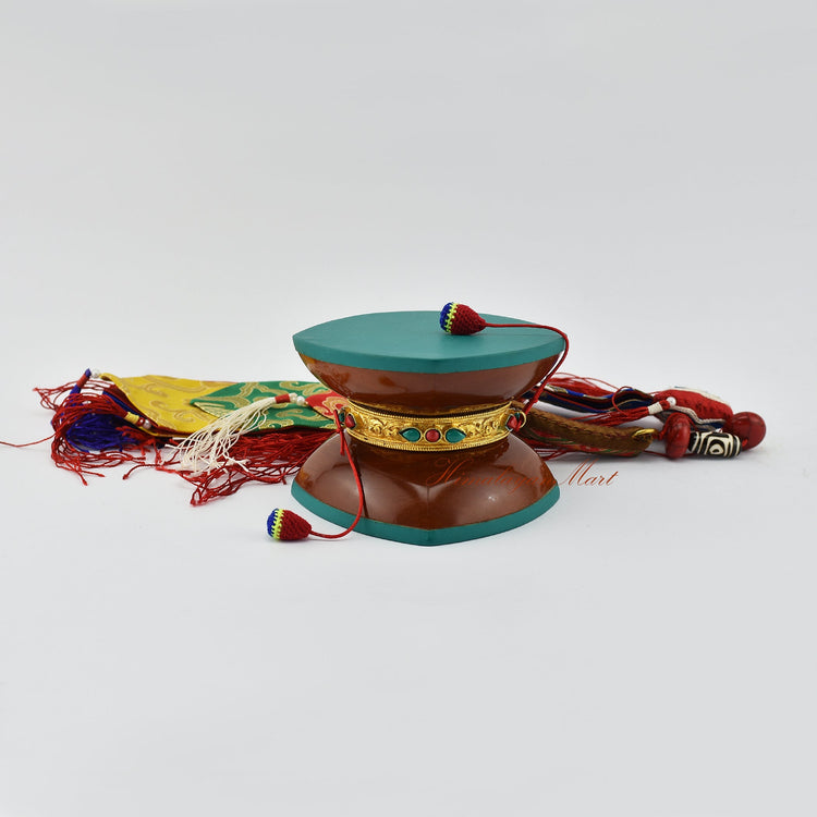 Handcrafted damaru ritual drum with silk tail used in Vajrayana Buddhism