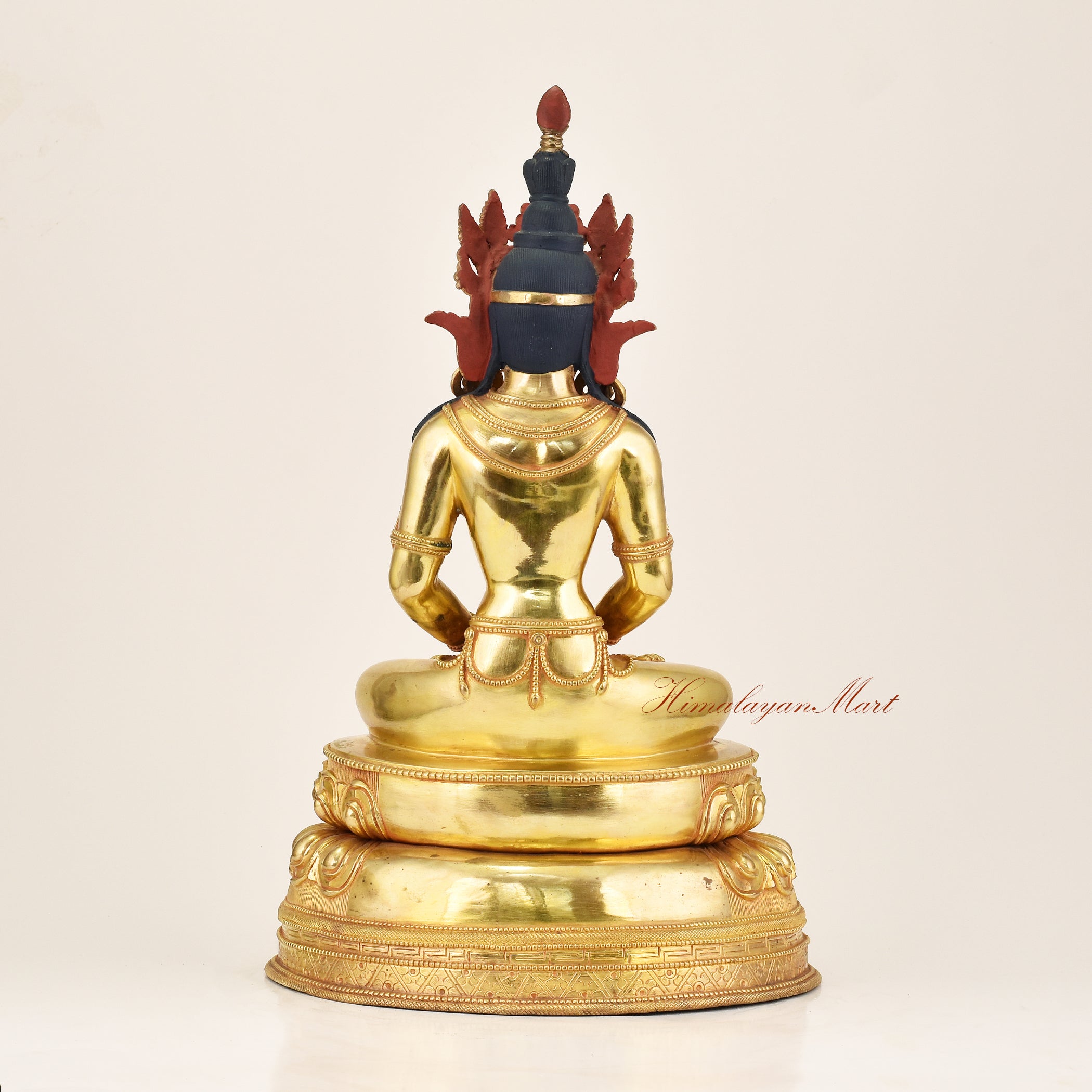 
Rear view of a lost-wax cast Amitayus statue in gold gilded copper alloy, displaying the detailed back carving and craftsmanship of Patan's Newar master artisans, Nepal
