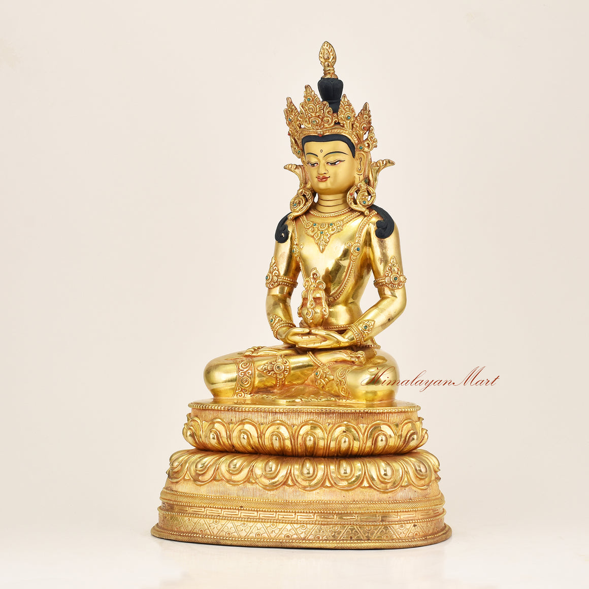 Left side view of a handcrafted Amitayus Buddha statue in 24K gold gilded copper, revealing bodhisattva crown, silk robe carvings, and coral stone embellishments, Nepal