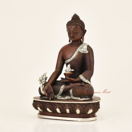 Left side view of Antique Medicine Buddha Statue showing hand-carved detail