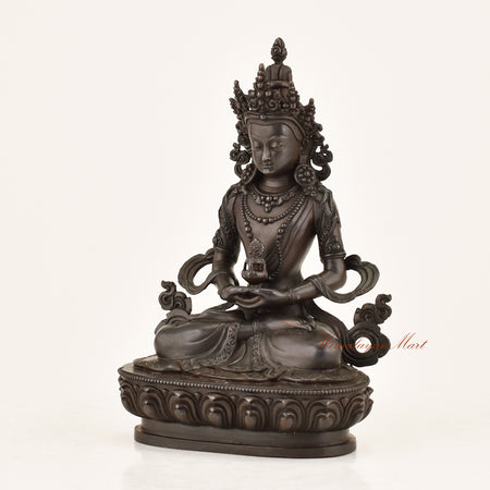 Left side view of the Aparimita Statue revealing intricate copper alloy craftsmanship, armlet adornments, and lotus throne detailing by Nepali master artisans