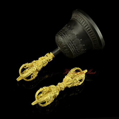 Left side view of copper and bronze Dorje and Drilbu set, showing the antique-style patina and yellow handle detail