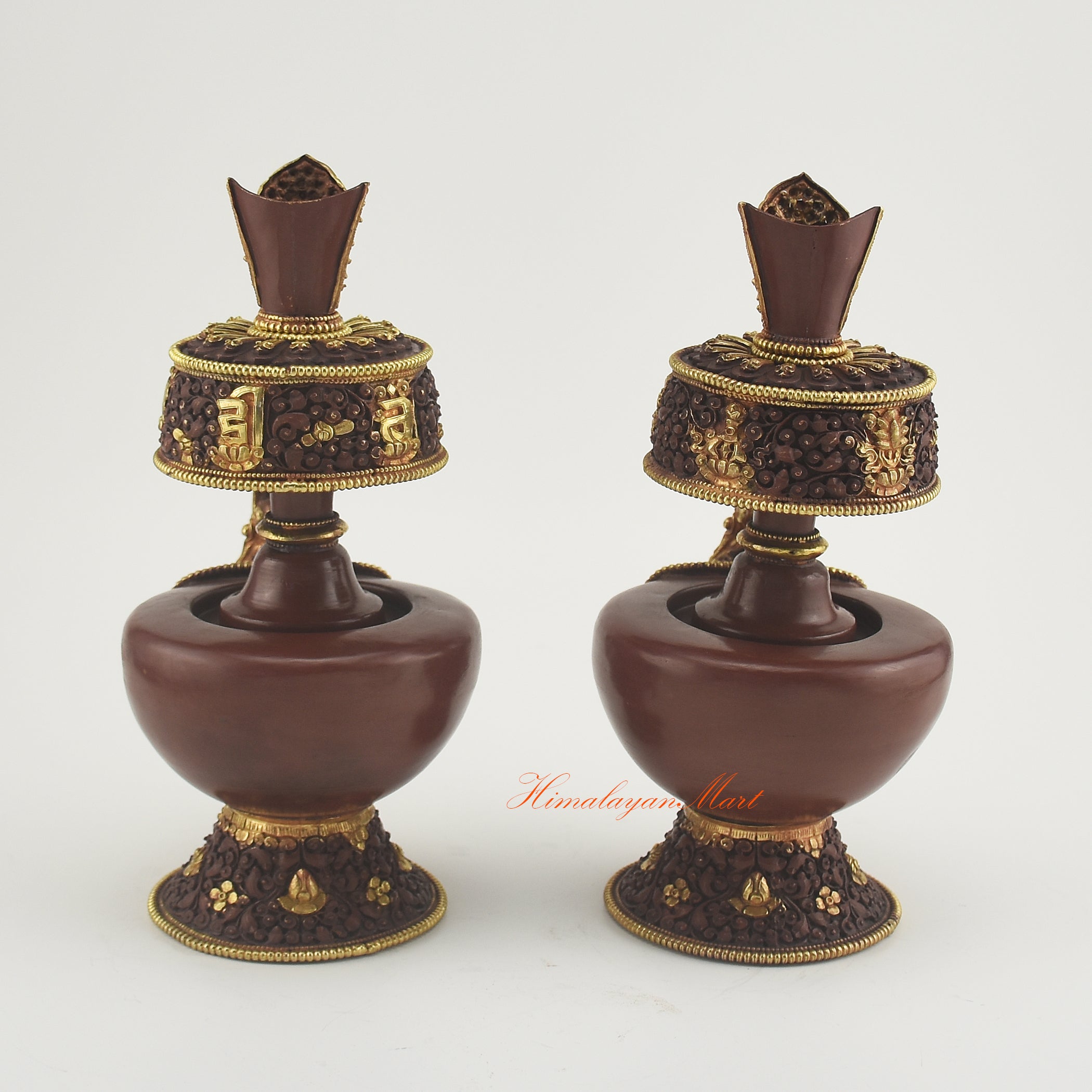 Back view of the Bhumba Ritual Container showing intricate hand-carved Buddhist motifs and polished gold-plated finish.