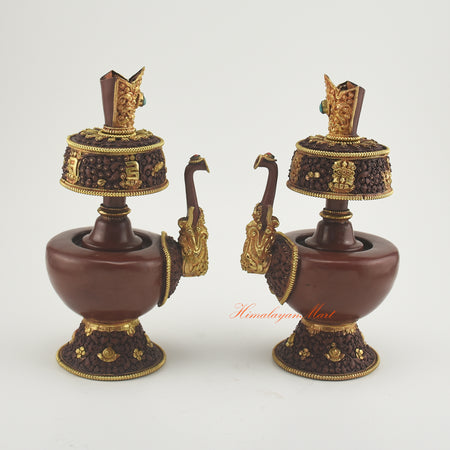 Pair of Bhumba Ritual Containers placed together, showcasing artisan craftsmanship with gold plating and semi-precious stones.