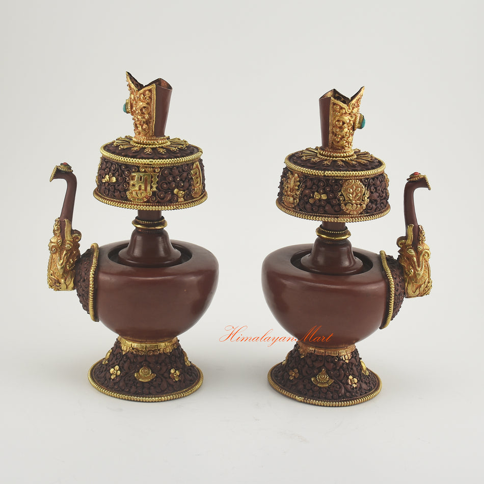 Outward-facing view of Bhumba Ritual Container highlighting hand-carved Buddhist designs and decorative coral and turquoise stones.