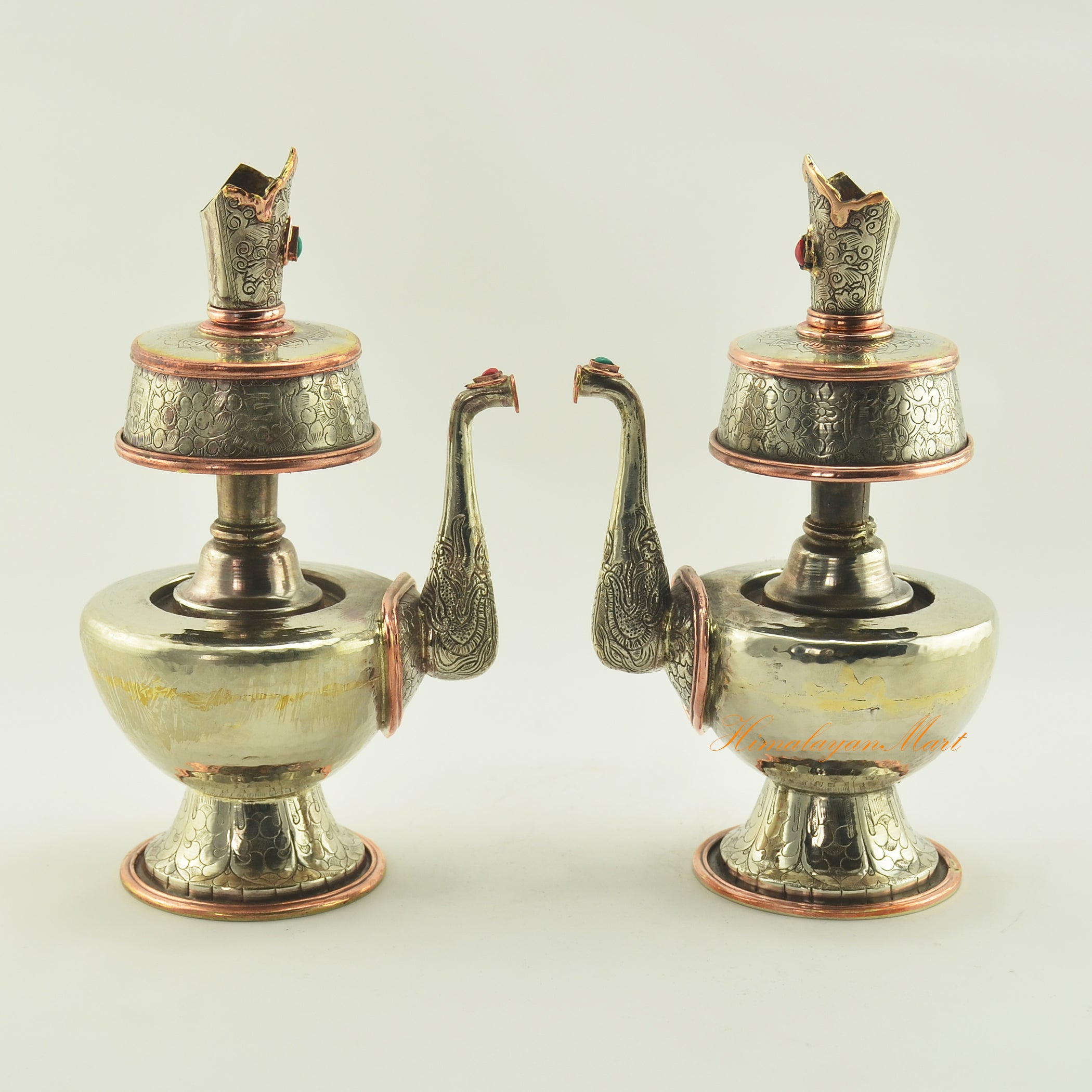 Pair of Bhumba Tibetan Ritual Vases displayed together, handcrafted in white metal with copper accents