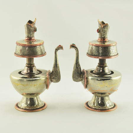 Pair of Bhumba Tibetan Ritual Vases displayed together, handcrafted in white metal with copper accents