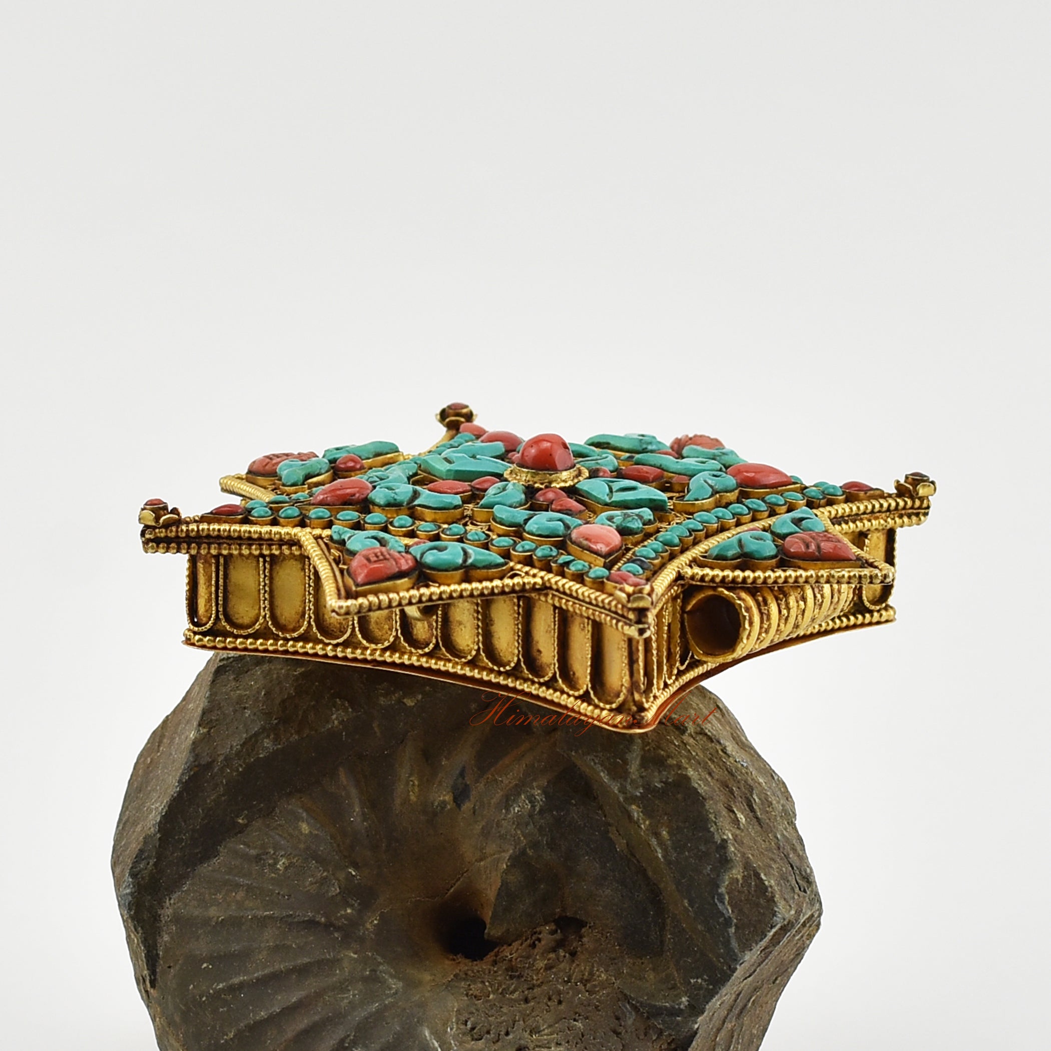 Left-side view of the Buddhist Religious Prayer Box Pendant highlighting coral flower centerpiece and intricate filigree details.