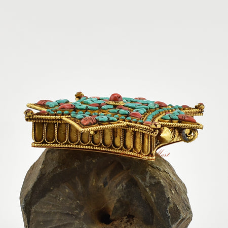 Right-side view of the Buddhist Religious Prayer Box Pendant showing detailed filigree work and coral and turquoise embellishments.
