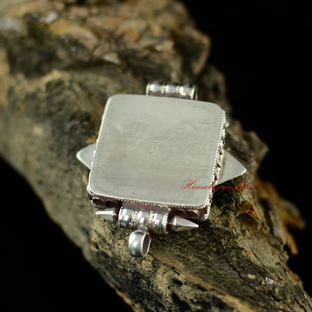 Back view of the handmade Buddhist silver pendant showcasing detailed Tibetan craftsmanship.