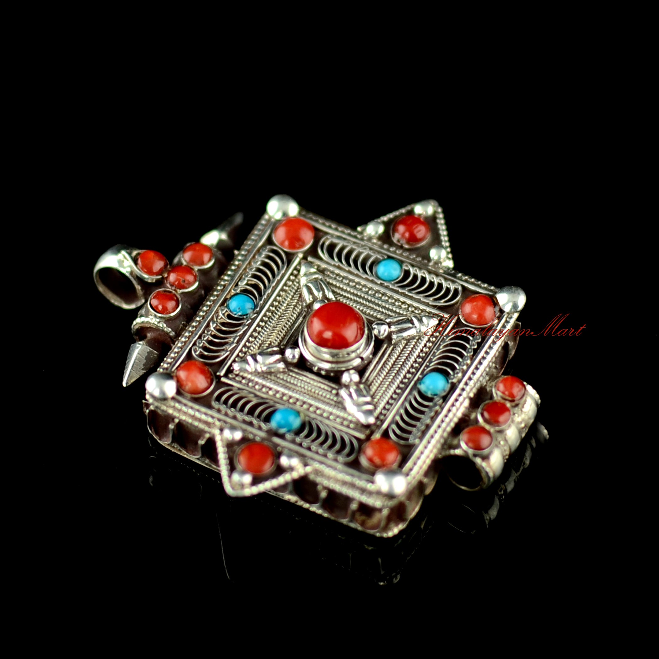 Left-side view of the handcrafted Buddhist silver pendant featuring traditional Tibetan filigree work.