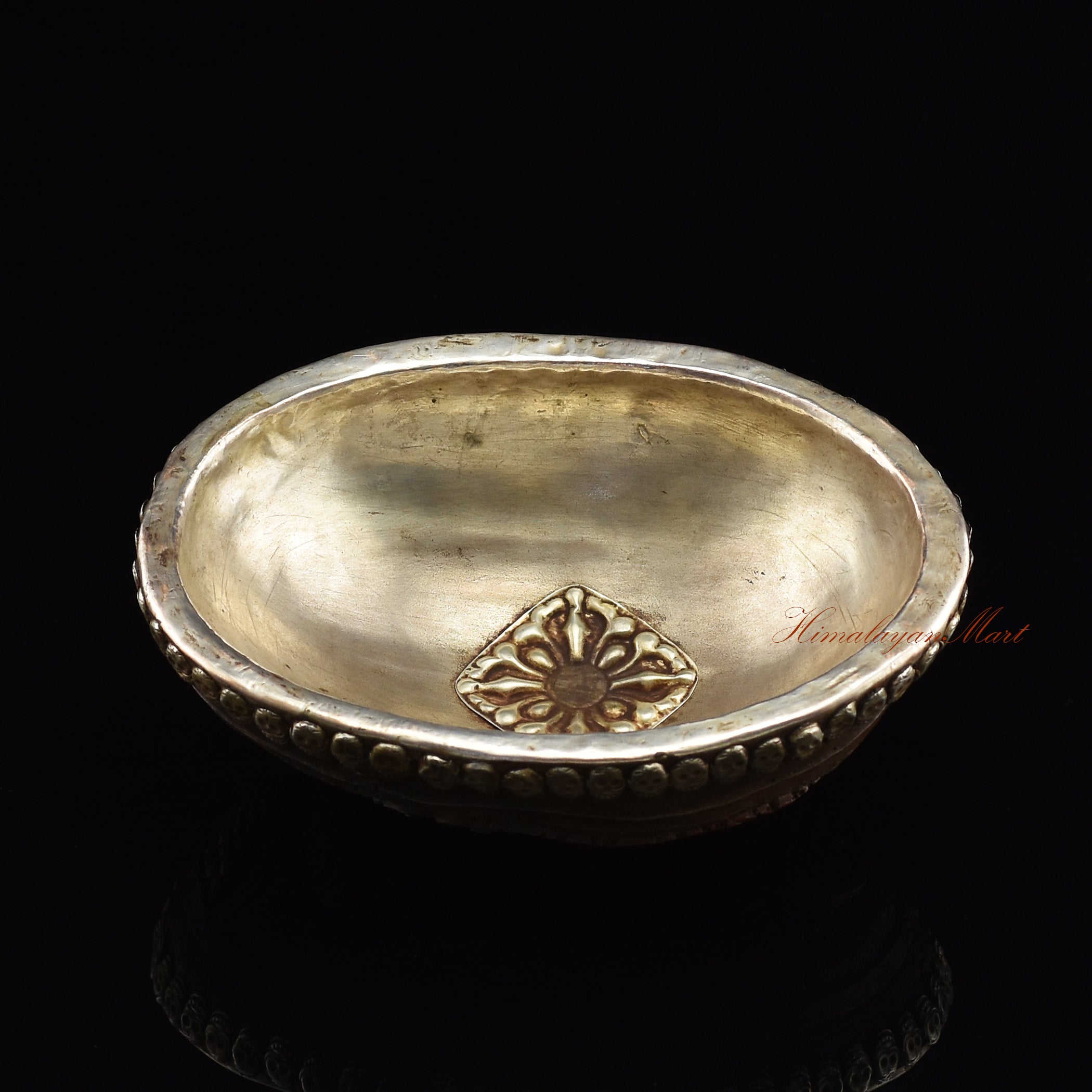 Chenrezig carved resin kapala, angled view highlighting hand-painted craftsmanship