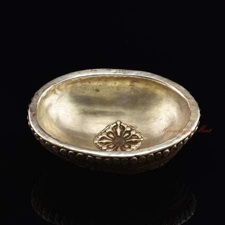 Chenrezig carved resin kapala, angled view highlighting hand-painted craftsmanship