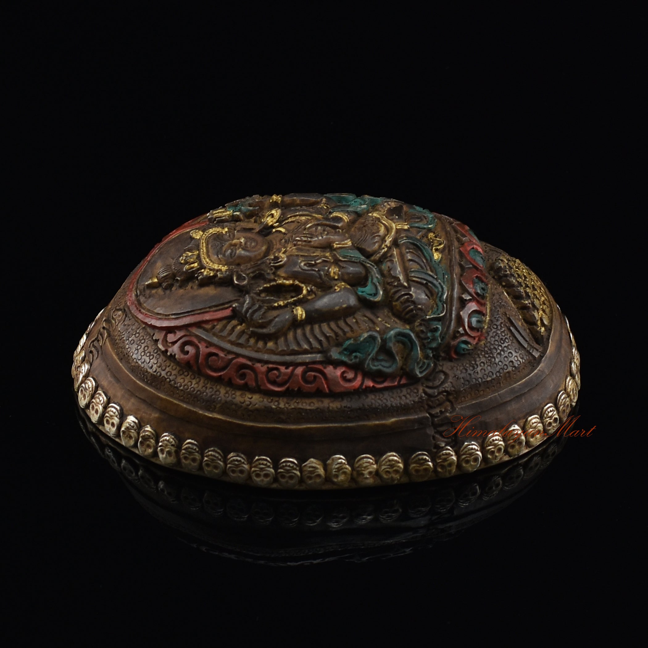 Chenrezig carved resin kapala, left side view showing metal skull detailing