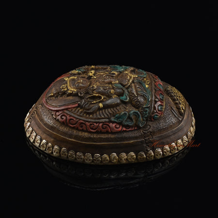 Chenrezig carved resin kapala, left side view showing metal skull detailing