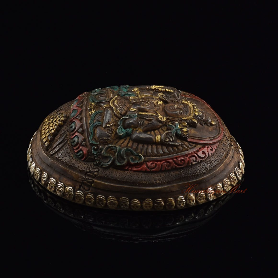 Chenrezig carved resin kapala, right side view with silver-plated copper accents