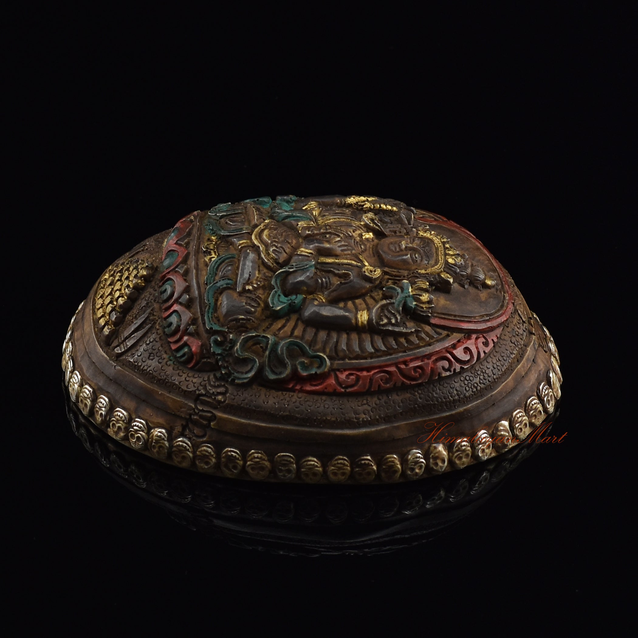 Chenrezig carved resin kapala, right side view with silver-plated copper accents