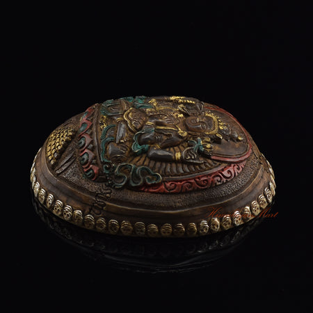 Chenrezig carved resin kapala, right side view with silver-plated copper accents