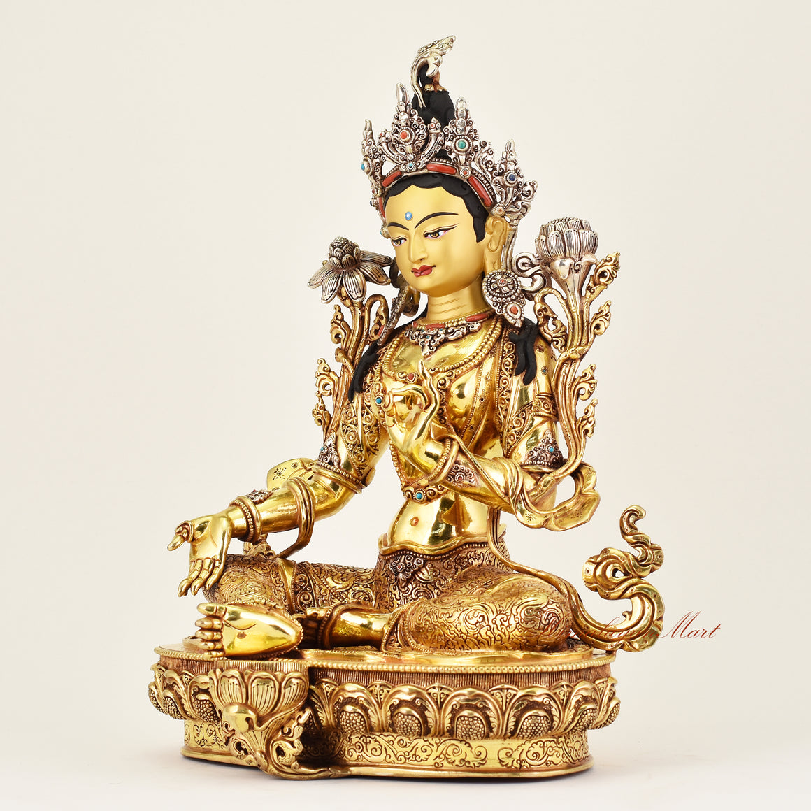 Left-side view of the Crowned Green Tara statue, highlighting detailed ornamentation, flowing robes, and serene expression of this Buddhist sacred sculpture.
