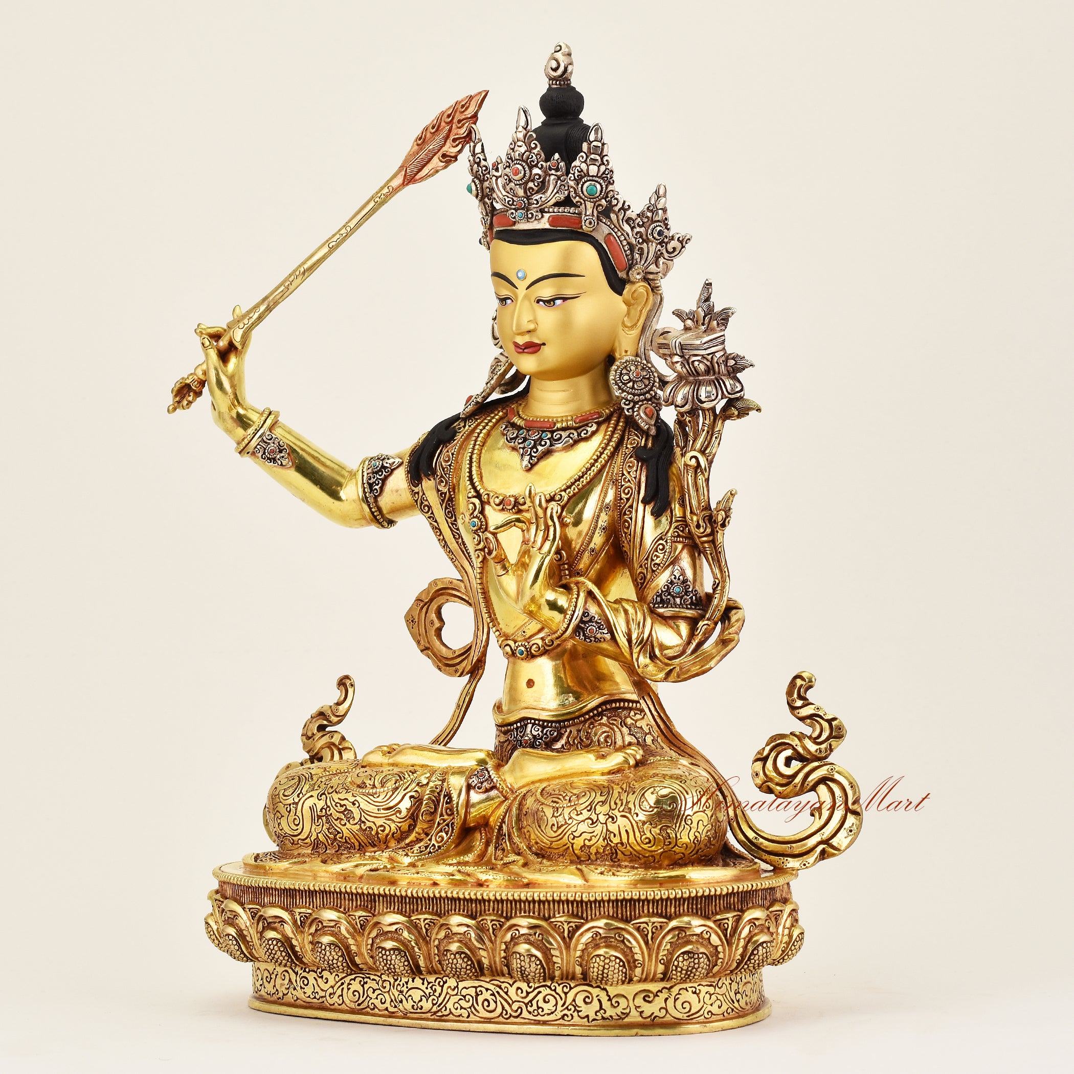 Left-side view of the Crowned Manjushri statue, showcasing intricate details, flowing robes, and serene expression of this Buddhist sacred sculpture.