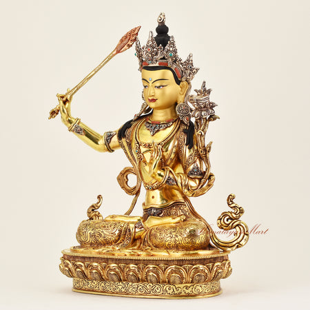 Left-side view of the Crowned Manjushri statue, showcasing intricate details, flowing robes, and serene expression of this Buddhist sacred sculpture.