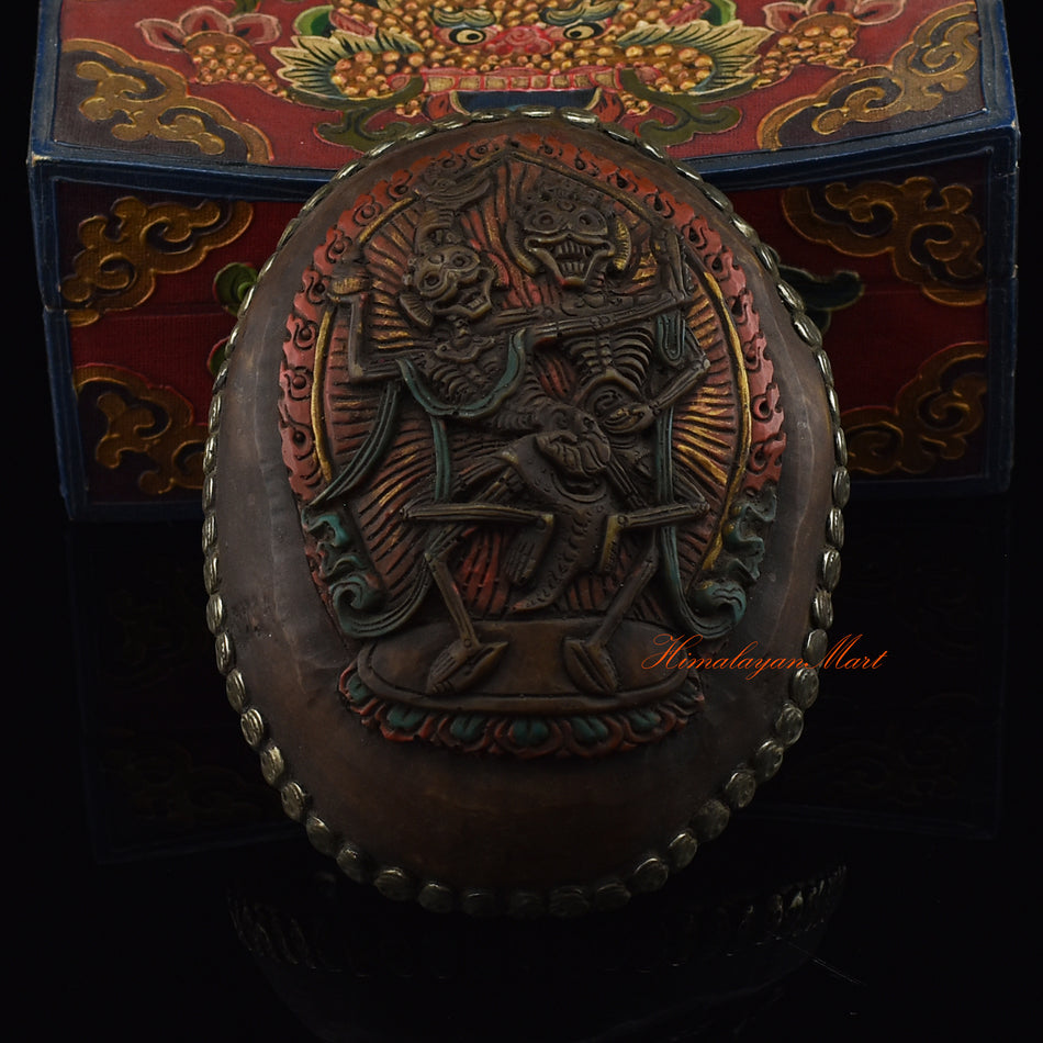 Dancing Citipati Resin Kapala with an intricately detailed metal skull border, front view