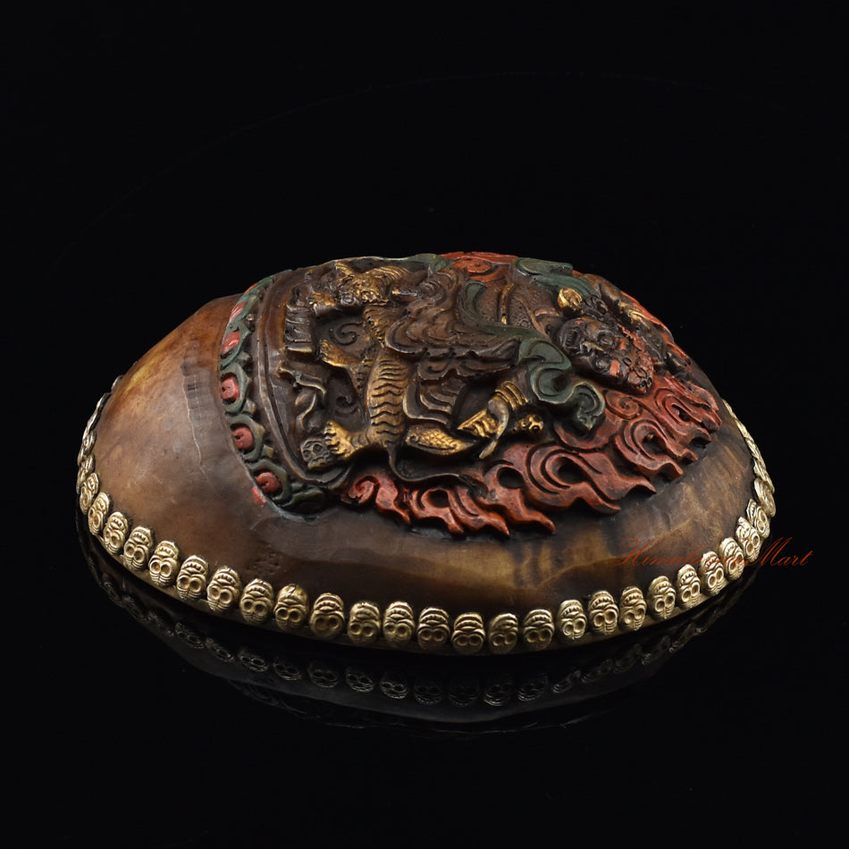 Right side view of the Dorje Drolo Carved Resin Kapala showing silver-plated copper accents and metal skull detail