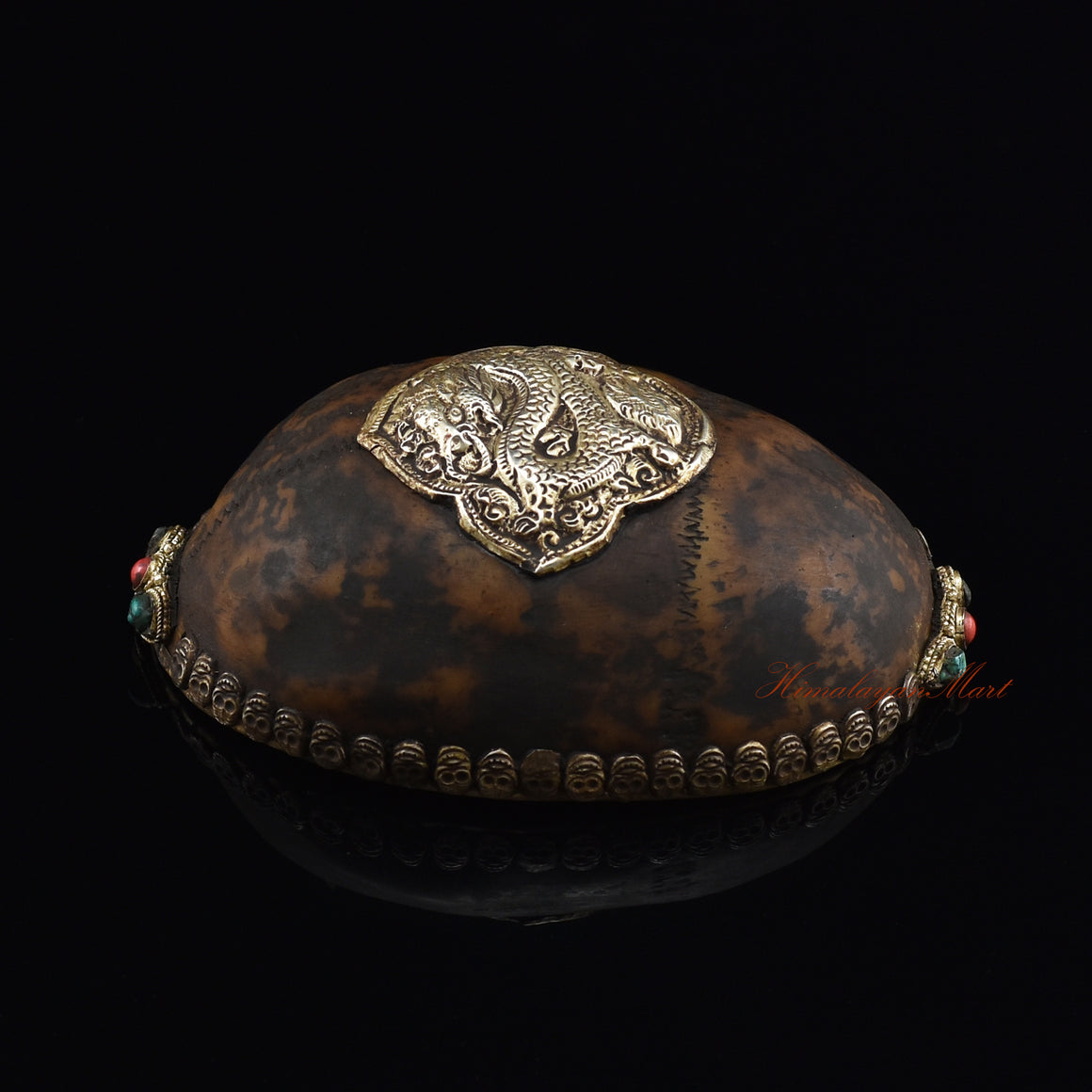 Dragon-embedded resin kapala, left side view showing dragon detailing