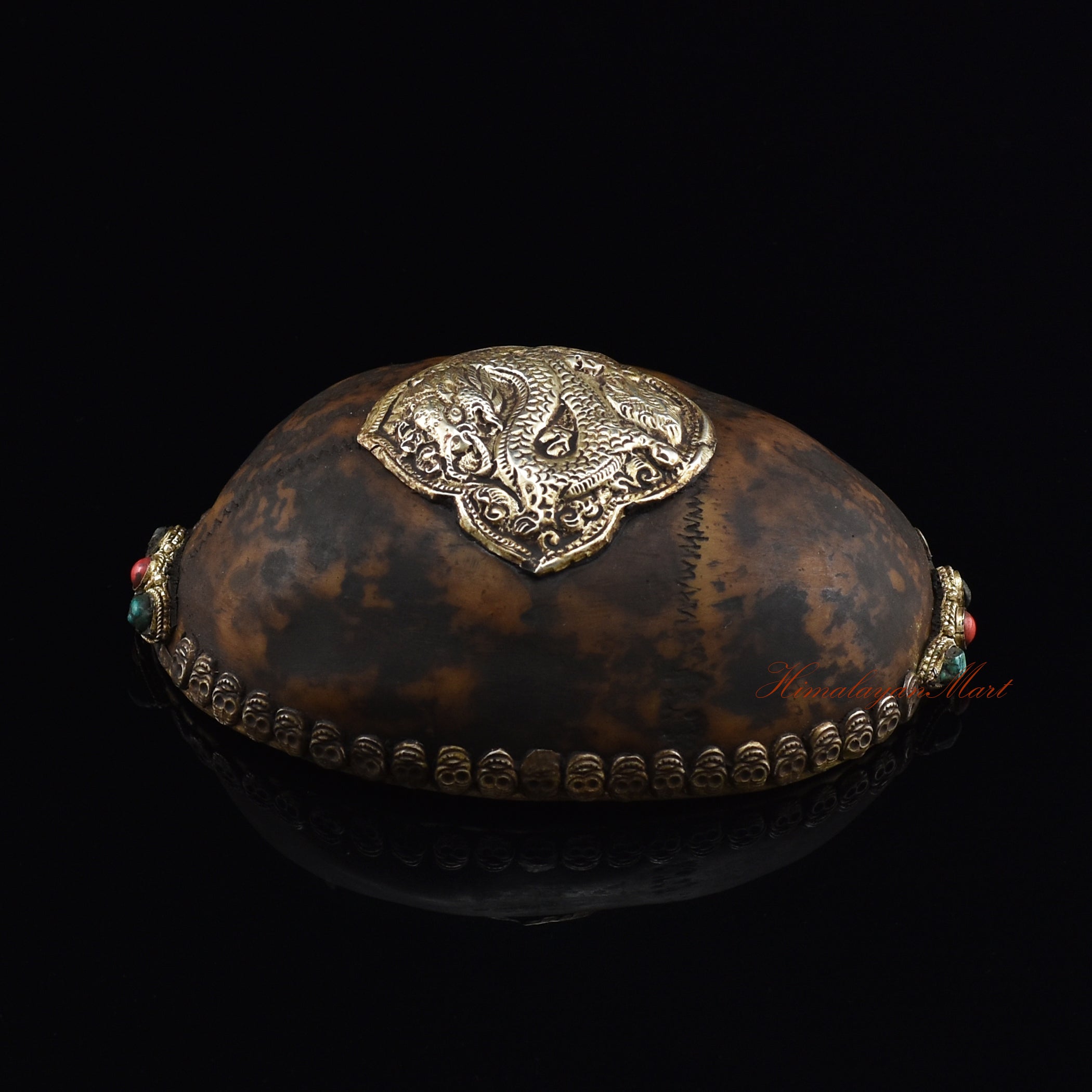 Dragon-embedded resin kapala, left side view showing dragon detailing