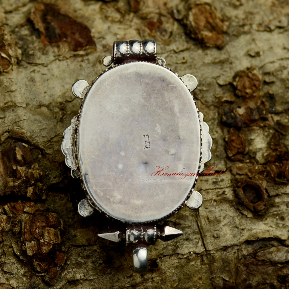 Back view of Dzambhala Wealth Deity Pendant displaying handcrafted silver ghau structure and filigree work.