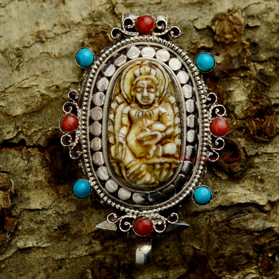 Dzambhala Wealth Deity Pendant crafted in silver ghau, featuring Yellow Dzambhala with coral and turquoise inlay.
