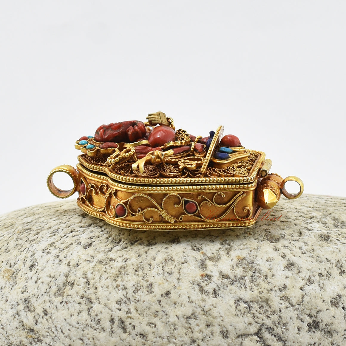 Left-side view of Ganesha Silver Ghau Pendant highlighting gemstone inlay and gold-plated silver finish.