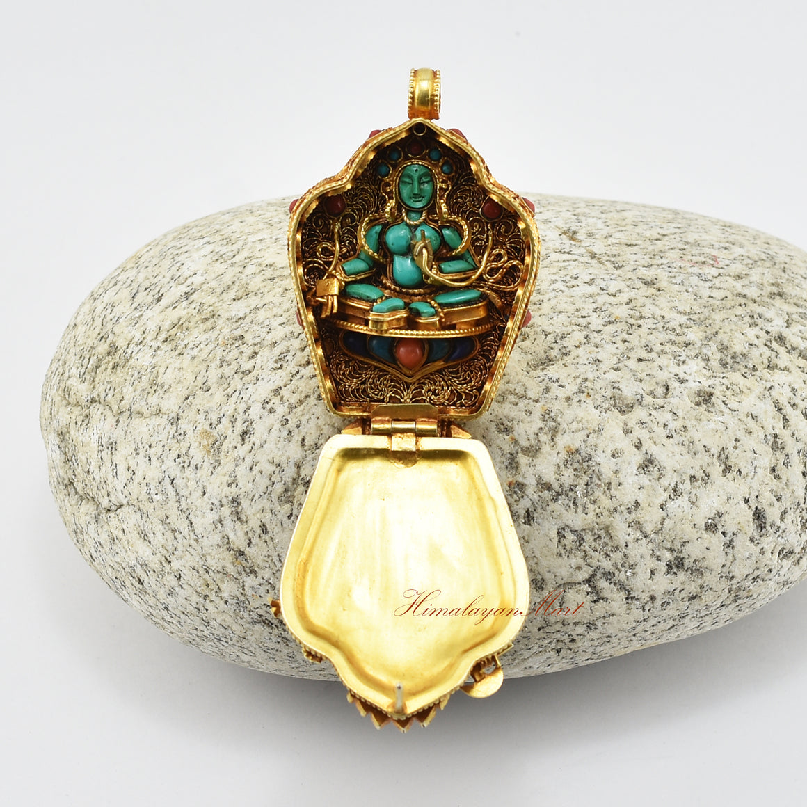 Open Ganesha Silver Ghau Pendant revealing Green Tara figure made of turquoise inside the prayer box.