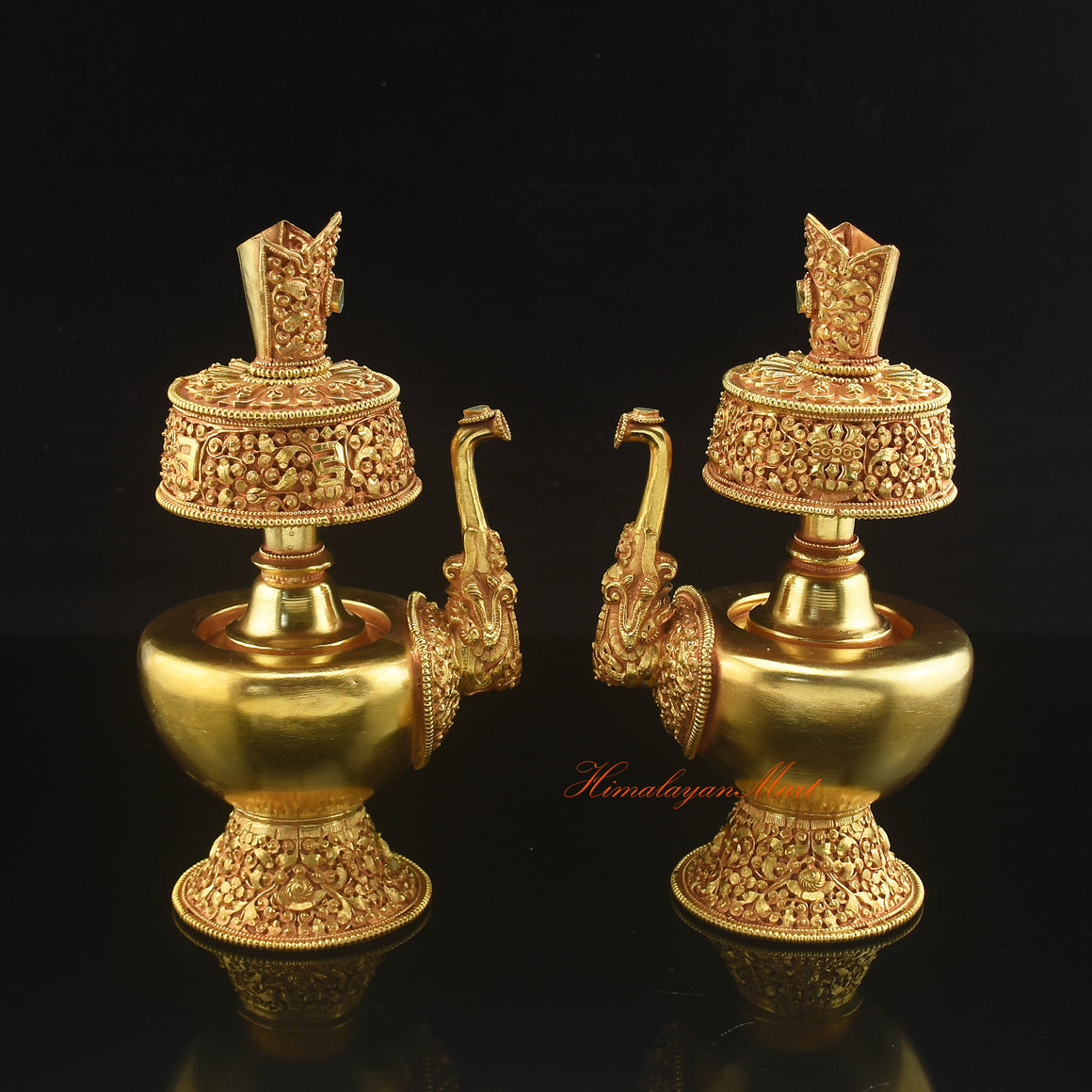 Pair of Gold Plated Bhumba sacred offering vases placed together for traditional Buddhist altar rituals.