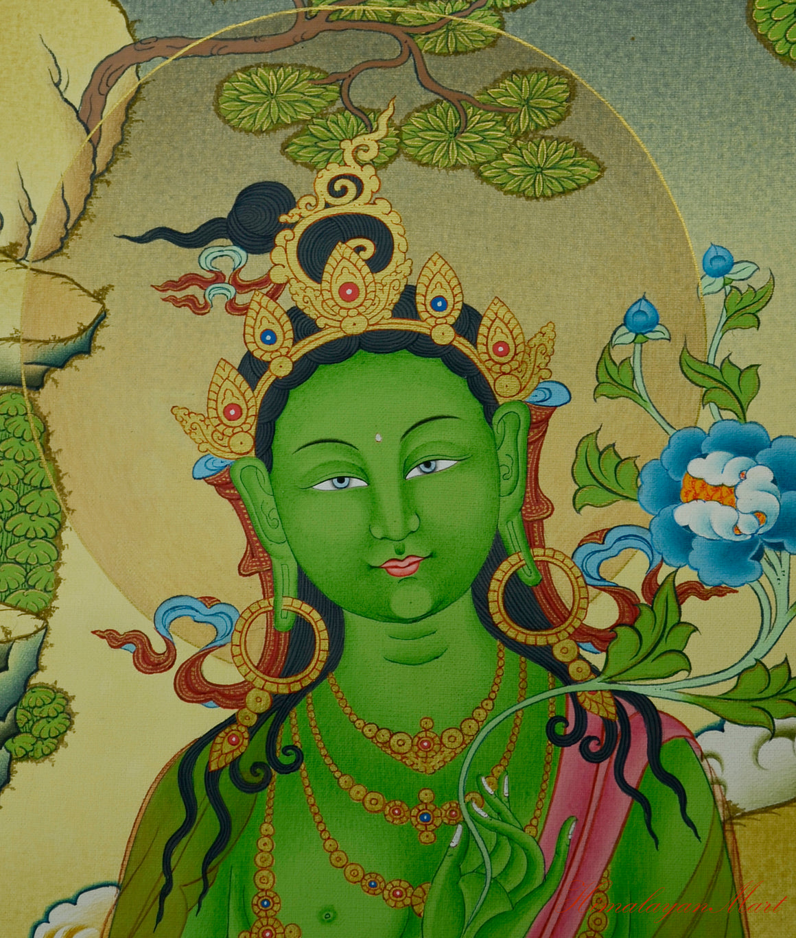 Close-up of Green Tara’s serene face in the Tibetan meditation thangka painting