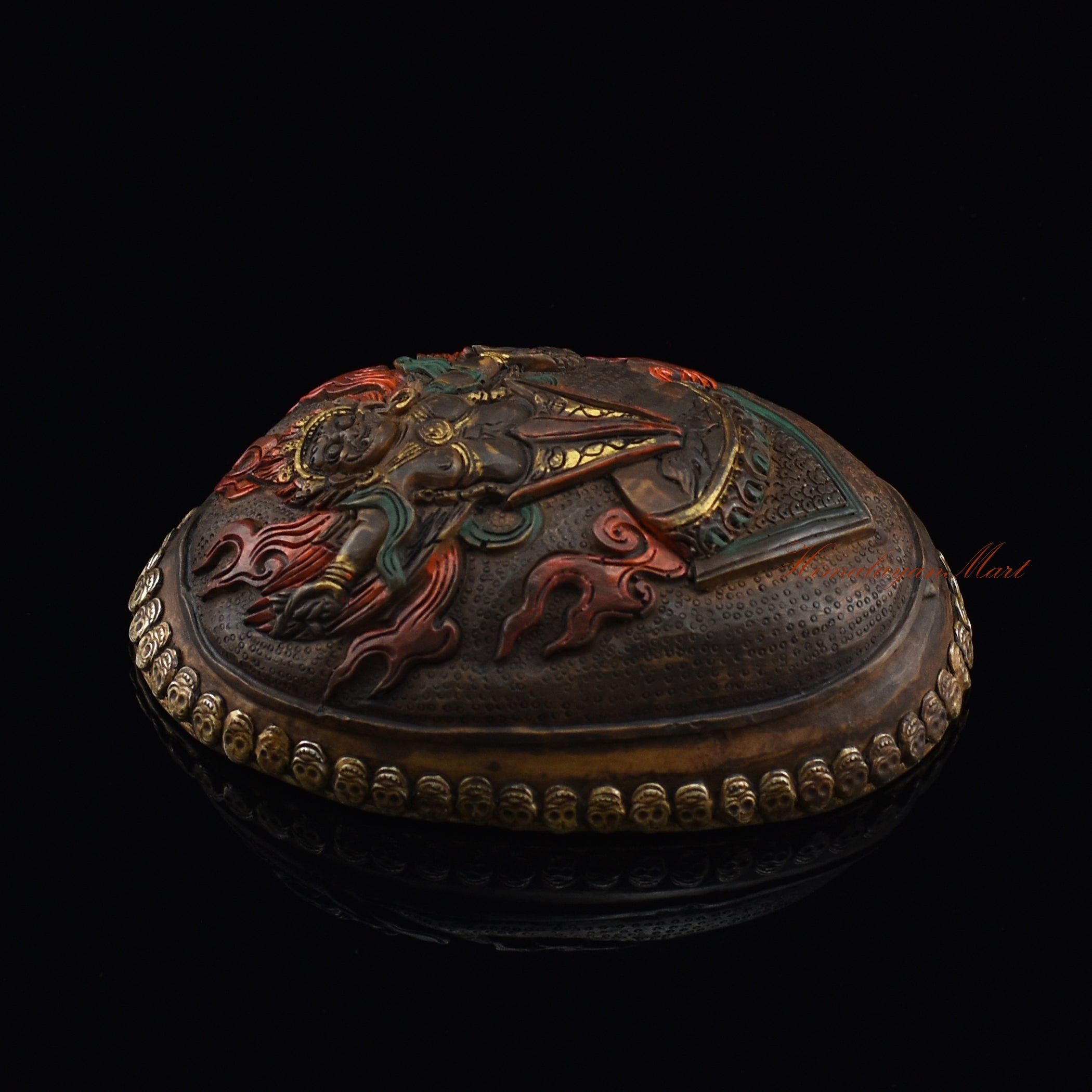 Left side view of the Guru Dragpur resin kapala with silver-plated copper accents
