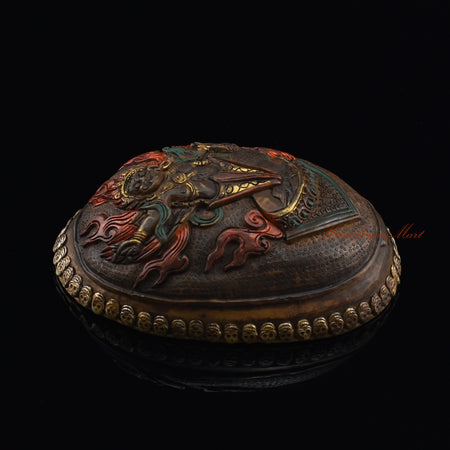Left side view of the Guru Dragpur resin kapala with silver-plated copper accents