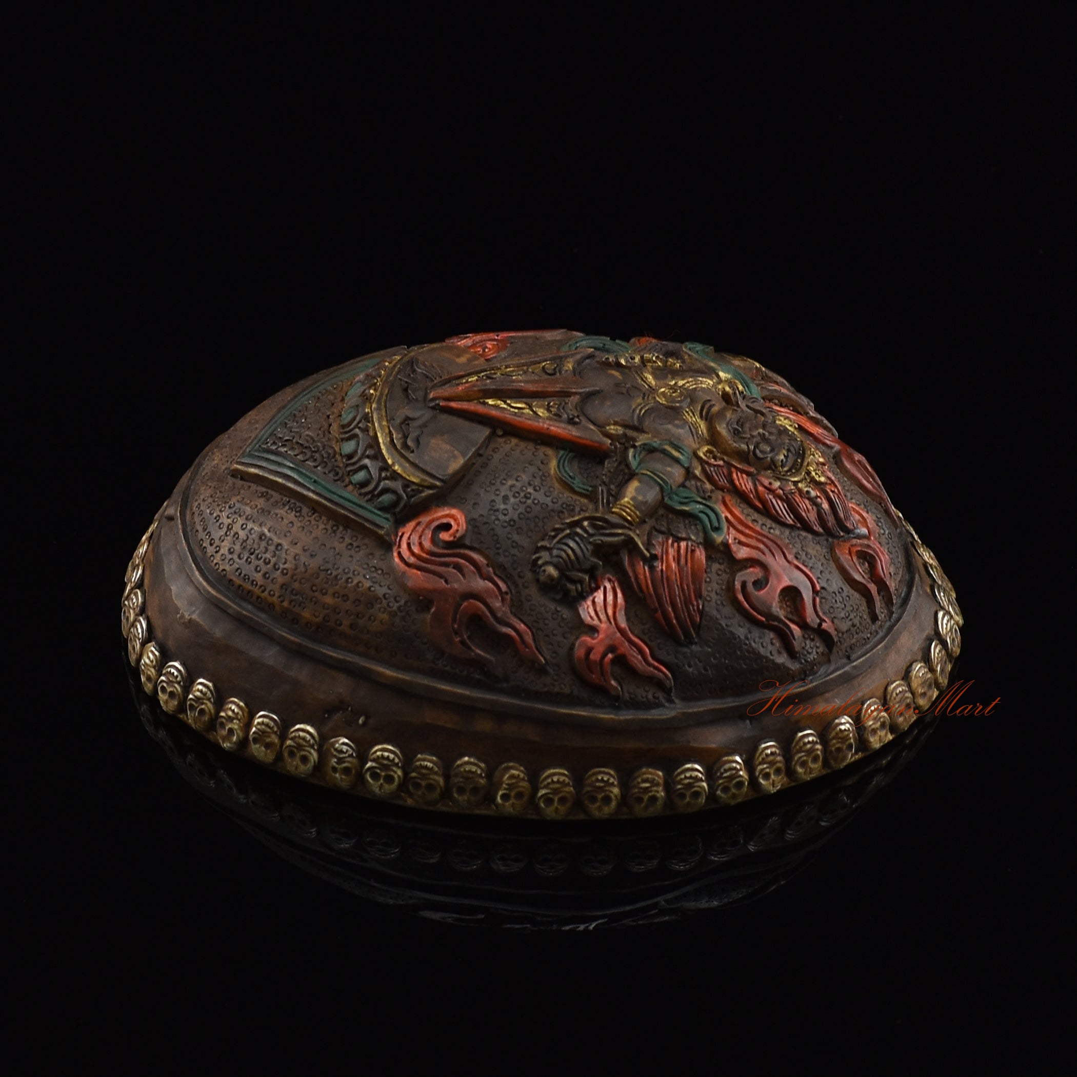 Right side view of the Guru Dragpur resin kapala showing carved metal skull border