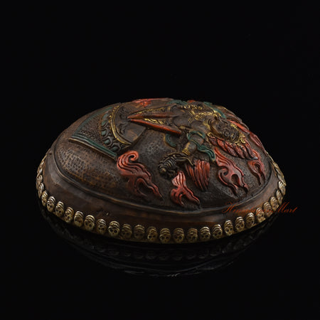 Right side view of the Guru Dragpur resin kapala showing carved metal skull border