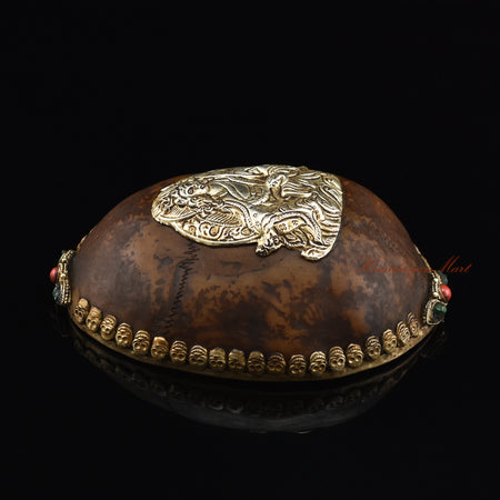 Left side view of the Guru Rinpoche-Embedded Resin Kapala highlighting the silver-plated copper metalwork