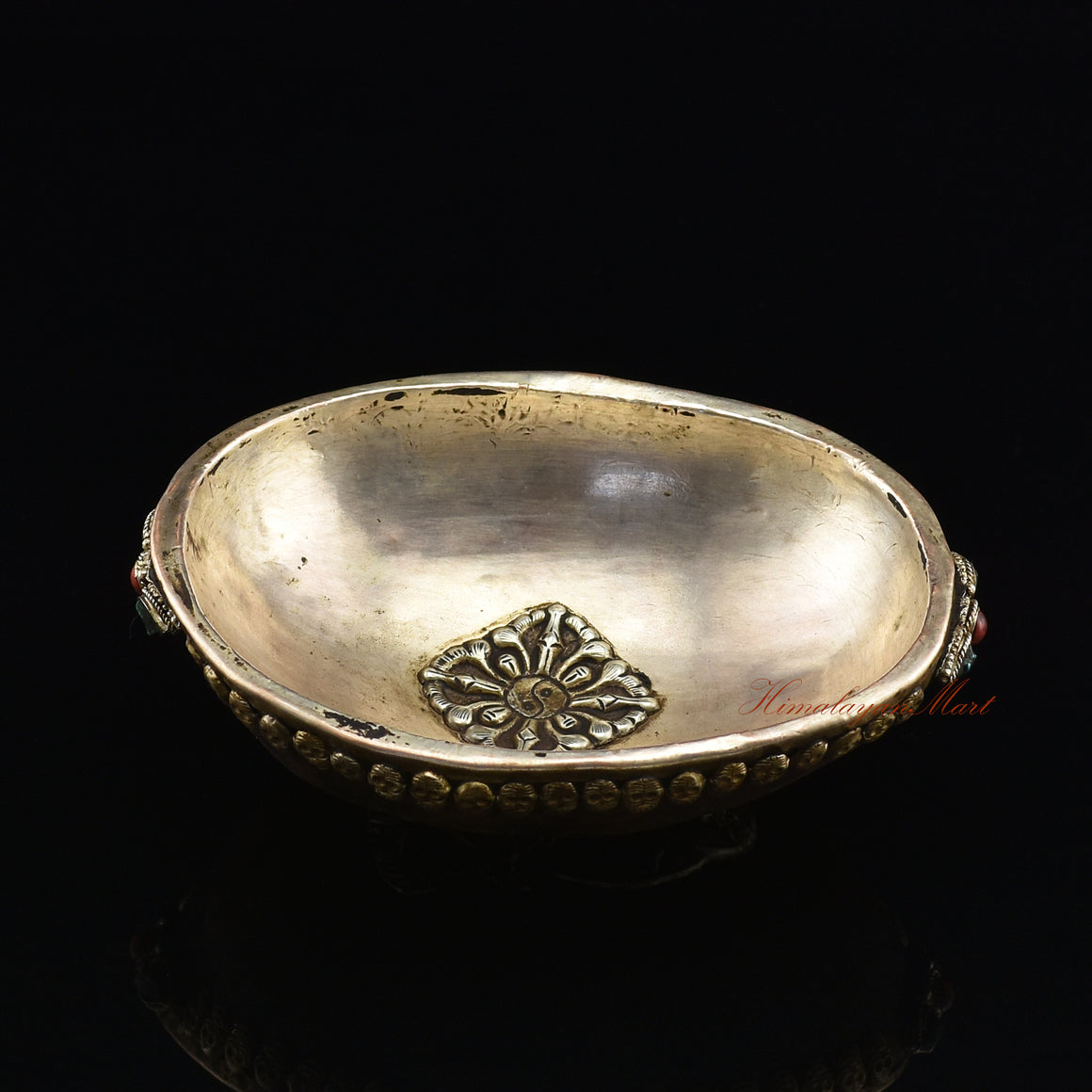 Overhead angled view of the Guru Rinpoche-Embedded Resin Kapala capturing the full ornate skull border and Guru Rinpoche imagery