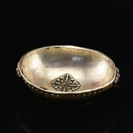 Overhead angled view of the Guru Rinpoche-Embedded Resin Kapala capturing the full ornate skull border and Guru Rinpoche imagery