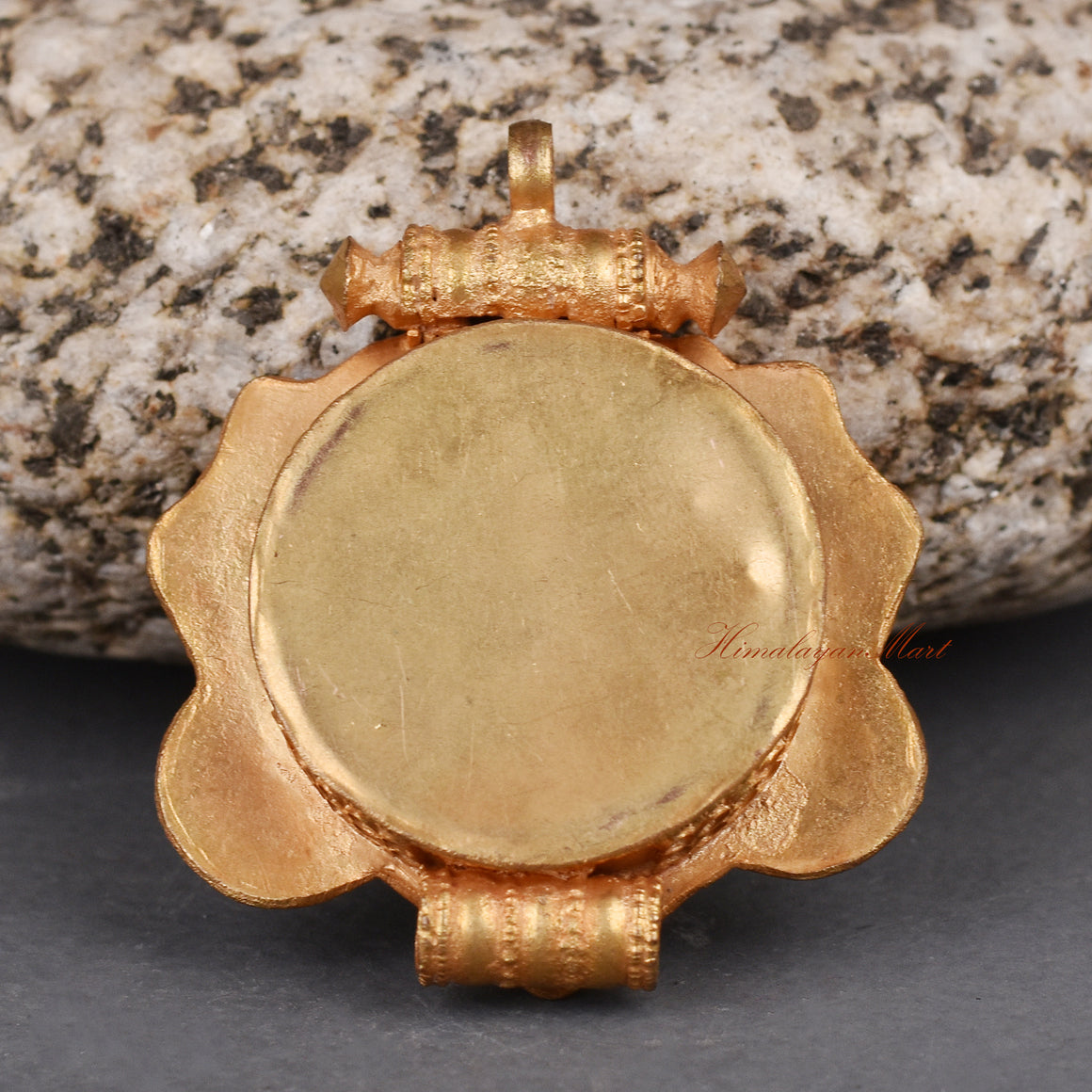 Back view of handcrafted Cheppu Face Ghau pendant prayer box showcasing detailed Nepalese metalwork.