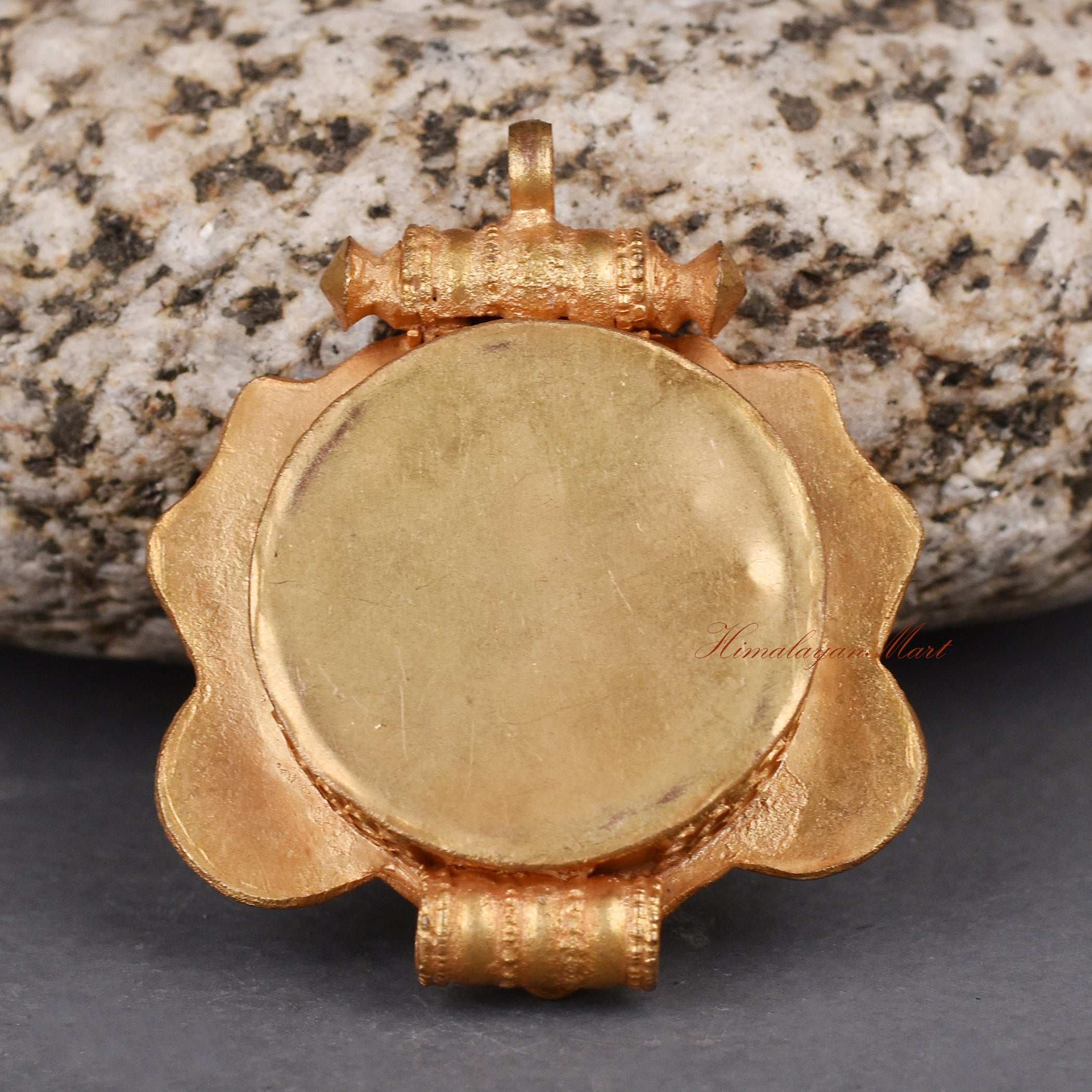 Back view of handcrafted Cheppu Face Ghau pendant prayer box showcasing detailed Nepalese metalwork.