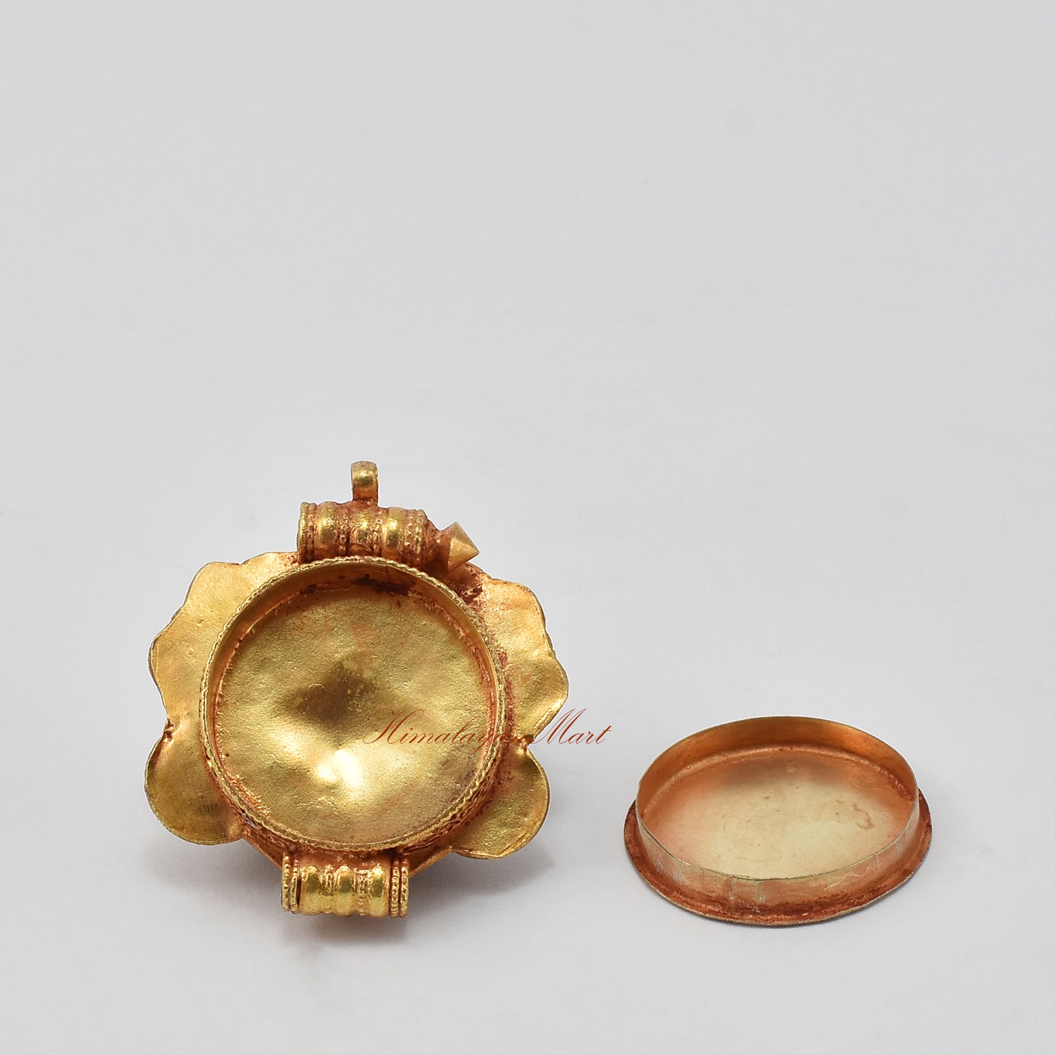 Opened view of Chhepu Face Ghau prayer box pendant, showing inner compartment for mantras, relics, or sacred items.