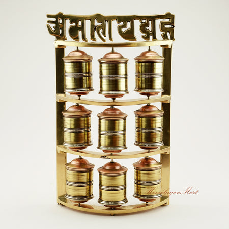Handcrafted Tabletop Prayer Wheel with nine small Mani wheels spinning during Buddhist meditation practice