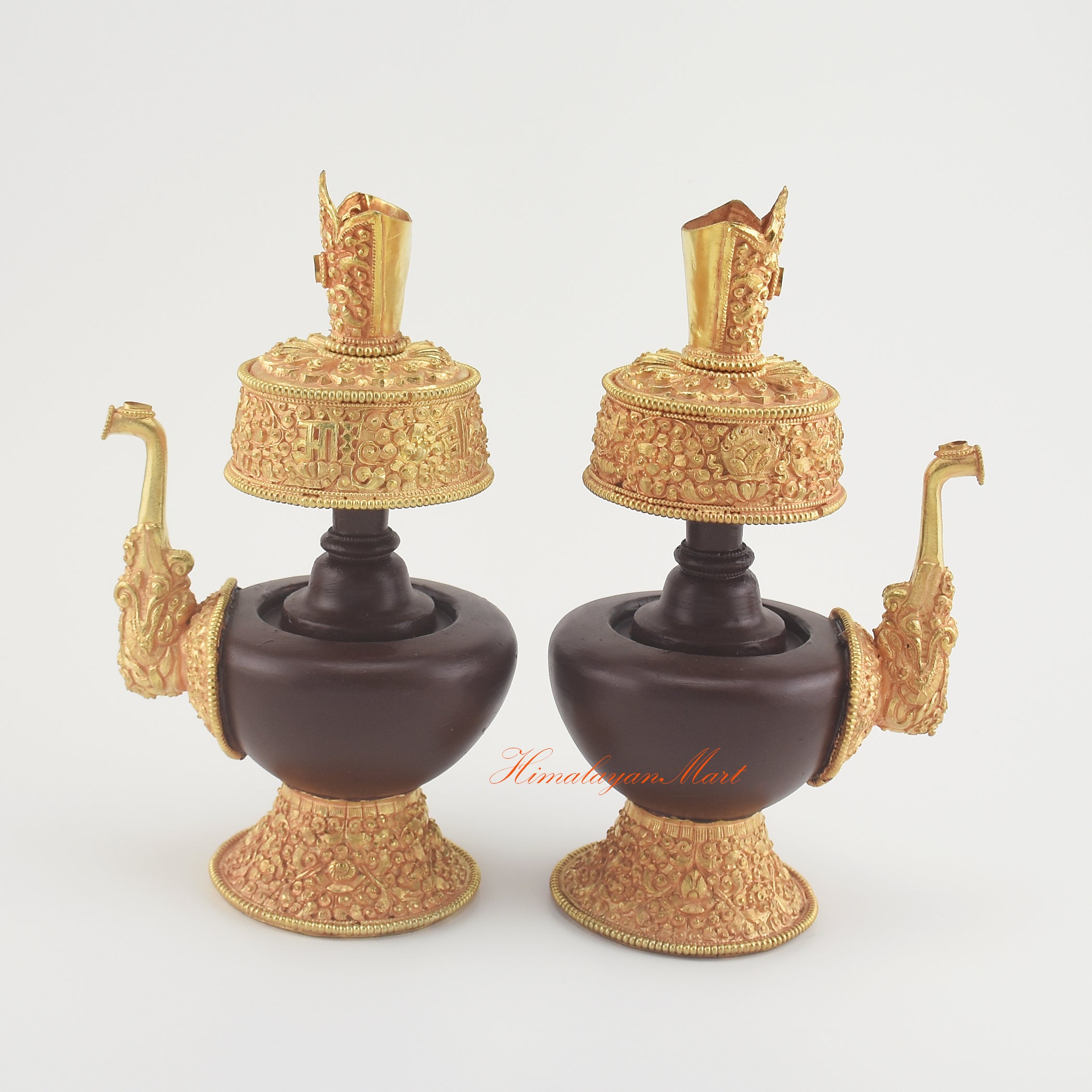 Outward-facing view of the Handcrafted Tibetan Bhumba Set highlighting carved Buddhist motifs and gold-plated accents.