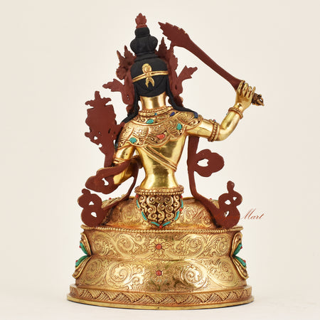 Back view of handmade Nepalese Manjushri statue displaying traditional hand-finished details and spiritual iconography
