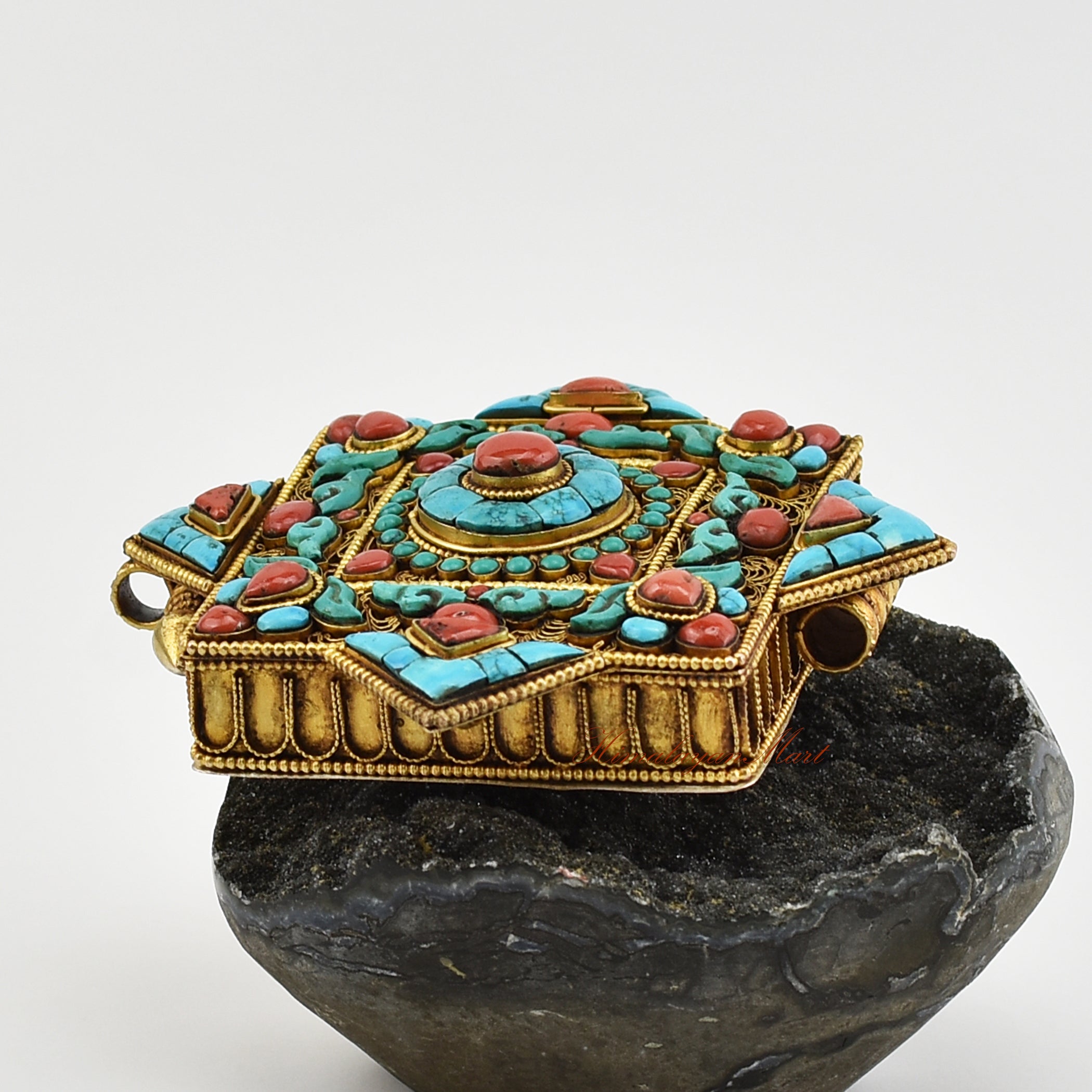 Left view of Handmade Religious Prayer Box Pendant highlighting intricate filigree work and gemstone inlays.